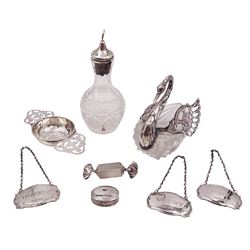 Group of silver, comprising tea strainer, silver mounted cut glass swan and bottle, three decanter labels 'Whisky' 'Port' and 'Brandy' and a two pill boxes one in the form of a sweet, all stamped or hallmarked, swan H10cm