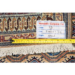 North East Persian Moud hand-knotted carpet, ivory field with an-over Herati inspired lattice of repeating lozenge and diamond motifs, with stylized floral devices and angular vinery in tones of sky blue, indigo, madder red and camel, principal border with a sequence of stylized palmettes and angular vine motifs, framed by narrow guard stripes, with cotton fringe ends