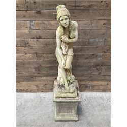Cast stone garden figure of a bathing lady, raised on square plinth