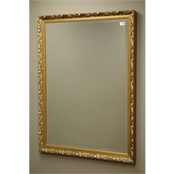  Bevelled mirror in swept gilt frame, 87cm x 112cm  