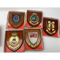 Various Navy wooden heraldic shields each with hand painted raised shield, including HMS Indefatigable, HMS Nelson,  HMS Victory etc, ten in total.  