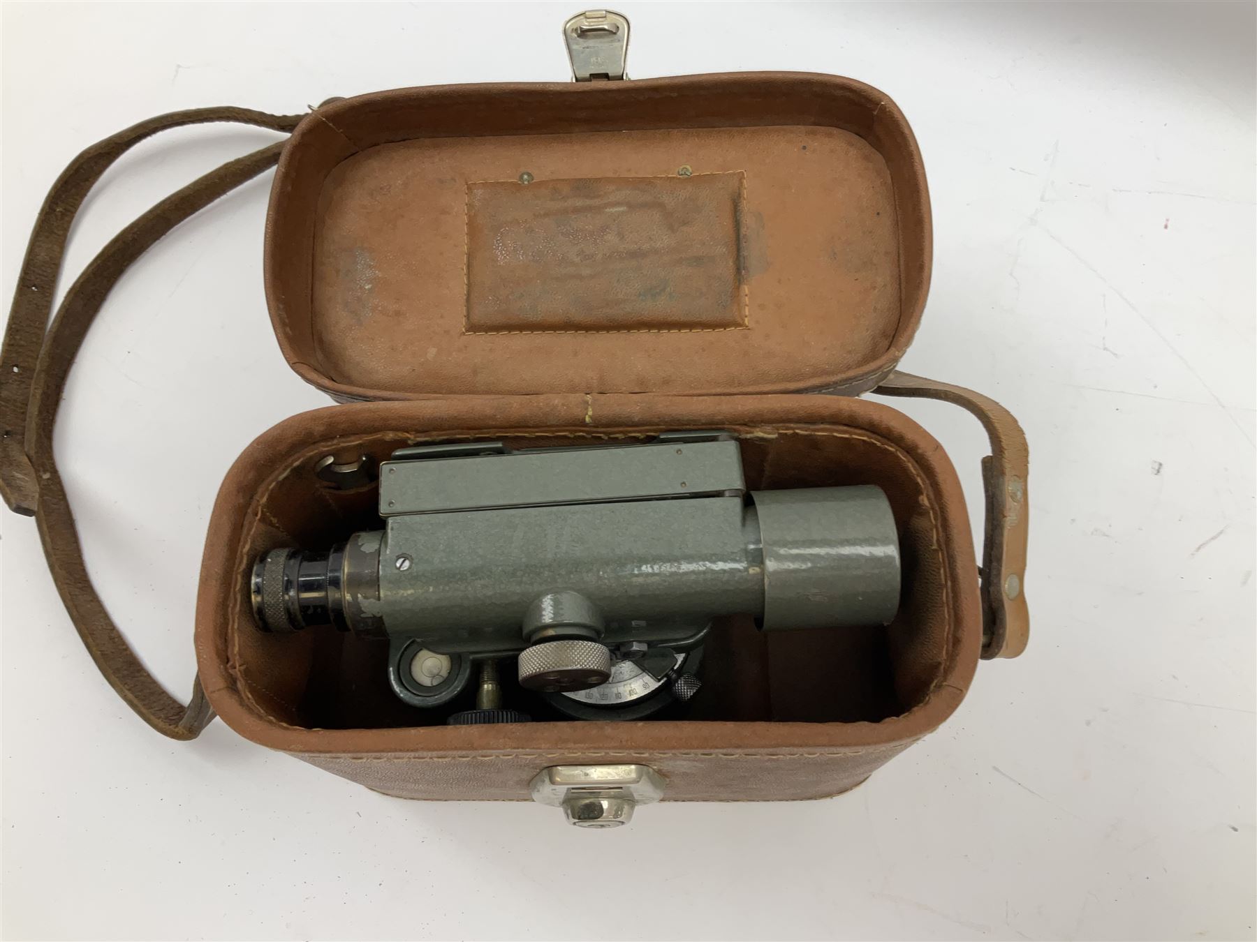 Black finished monocular microscope by Prior London No. 17372,  with pitchfork base and rack and pinion focusing, in original fitted wooden case with additional lenses, H32cm, together with Watts dumpy level, no. 116249, in a leather case