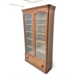 Victorian mahogany glazed bookcase enclosing adjustable shelving fitted with single drawer, plinth base 