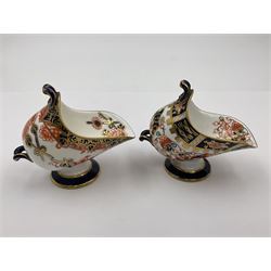 Group of Crown Derby and Royal Crown Derby Imari pattern miniatures, including mid 19th century Stevenson and Hancock cauldron, with painted mark beneath, H5.5cm, a near pair of early Royal Crown Derby scuttles, decorated in the 6299 pattern, each with printed and painted marks beneath including illustration date codes for 1913 and 1922, tallest 6.5cm, and a further early 20th century Royal Crown Derby scuttle, decorated in the 6299 pattern, with printed and painted marks beneath including illustration date code for 1922, H5.5cm, (4)
