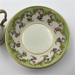 Sèvres soft paste porcelain coffee can and saucer with date code for 1754, painted and gilded with flowers, dangling from the shaped green border, interlaced LL monogram enclosing the date letter A above painters mark for Dodin, coffee can H7cm, saucer D14.5cm