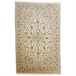 Central Persian Kashan hand-knotted carpet, ivory field with central lobed medallion issui...