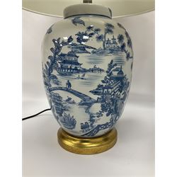 Pair of Chinese table lamps of baluster form, each decorated with landscape scene, raised upon gilt circular base, including shade H63cm