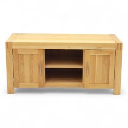 Contemporary solid oak television stand, rectangular top over an open central section with adjustable shelf, flanked by cupboard doors with vertical recessed panel fronts and brushed steel handles, on block feet