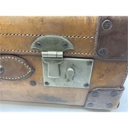 Vintage brown leather travel suitcase having studded leather corners with brass locks and catches and leather carrying handle, L60cm