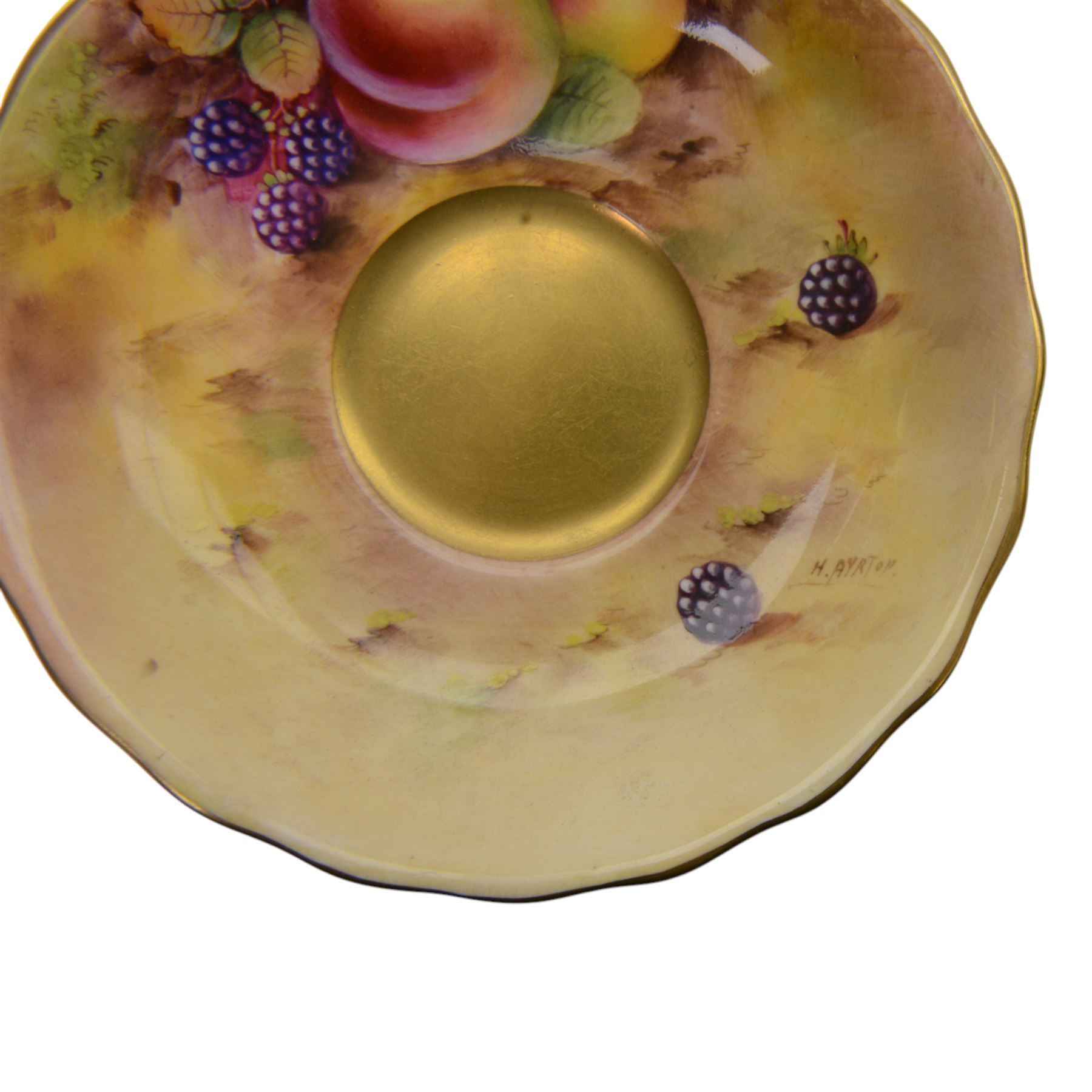 Royal Worcester fruit painted cabinet teacup and saucer, interior hand painted with apples, blackberry and cherries upon a mossy ground, the cup exterior and centre of saucer gilded, cup and saucer signed Rickells, each with puce coloured printed marks beneath, H7cm