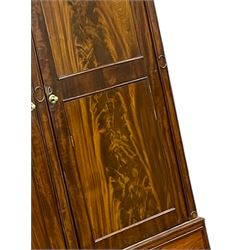 George III mahogany double wardrobe, the projecting cornice with dentil moulding over two panelled doors with mirror-lined interiors, enclosing hanging rails and brass hooks, the base fitted with two drawers, raised on bracket feet