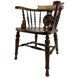 Late Victorian oak smokers bow armchair, with turned splat and spindle gallery over shaped seat, raised on turned supports united by double 'H' stretcher W61cm
