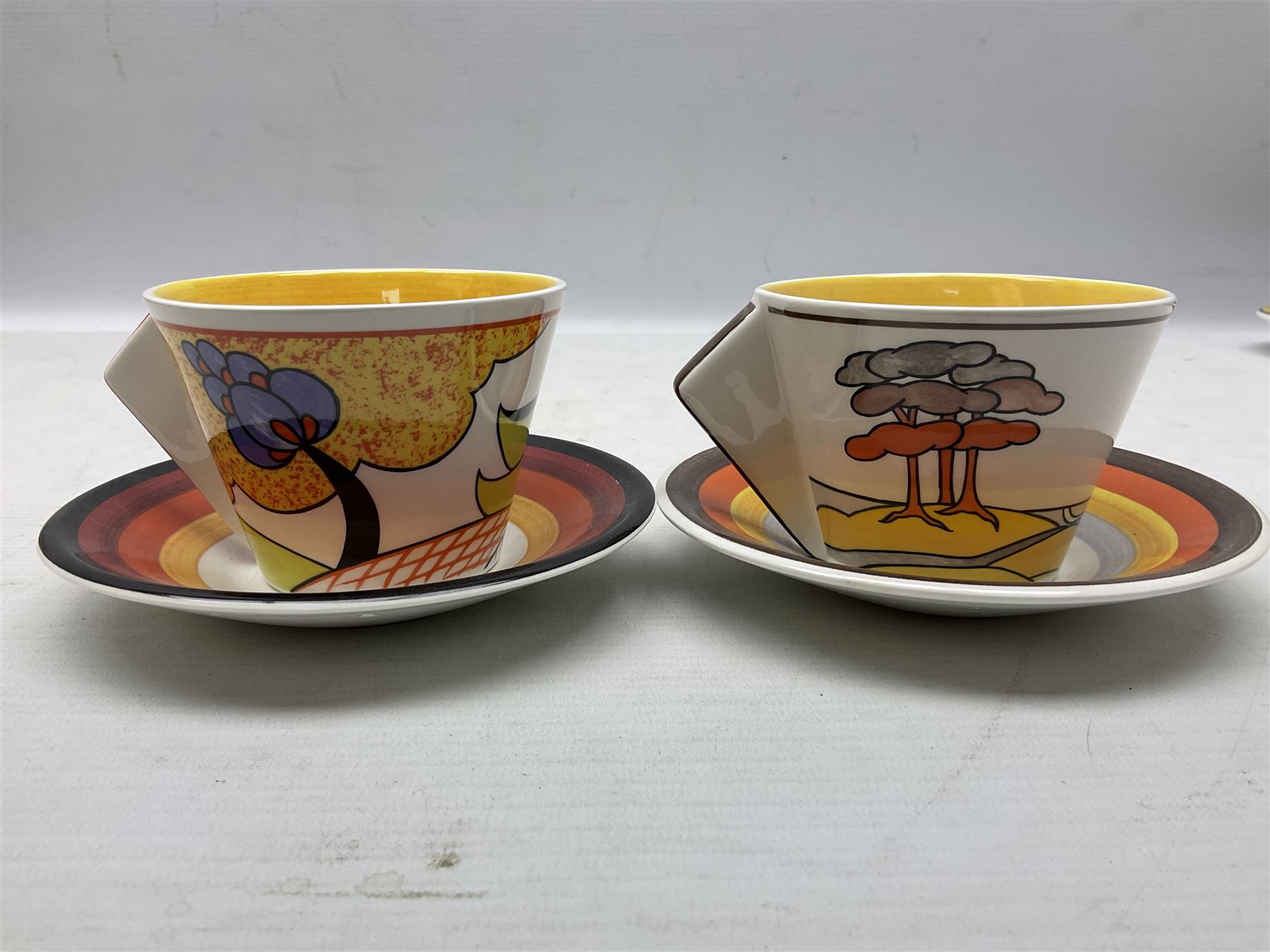 Wedgwood limited edition Clarice Cliff Design Taking Tea collection, comprising eight cups and saucers Honolulu, Apples, Gibraltar, Lilac Crocus, Trees and House, Coral Firs, Devon, and Sunray, with certificates of authenticity 