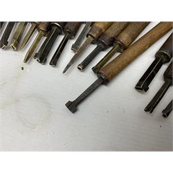 Thirty-one bookbinder's brass number and letter stamps, predominantly with beech handles, together with a bookbinder' decorative fillet roll, with brass triple line wheel stamped E. Menuel London, with wood handle, and two ink blotters