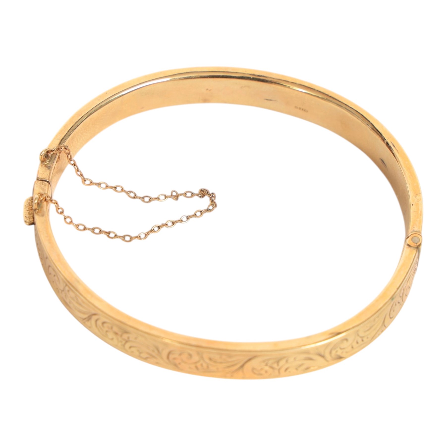 9ct gold hinged bangle, with engraved foliate decoration, hallmarked