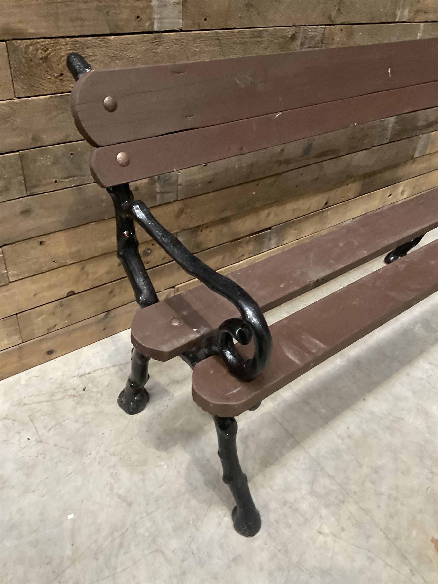 20th century tree cast iron and timber slatted garden bench, black painted frame with stained wood