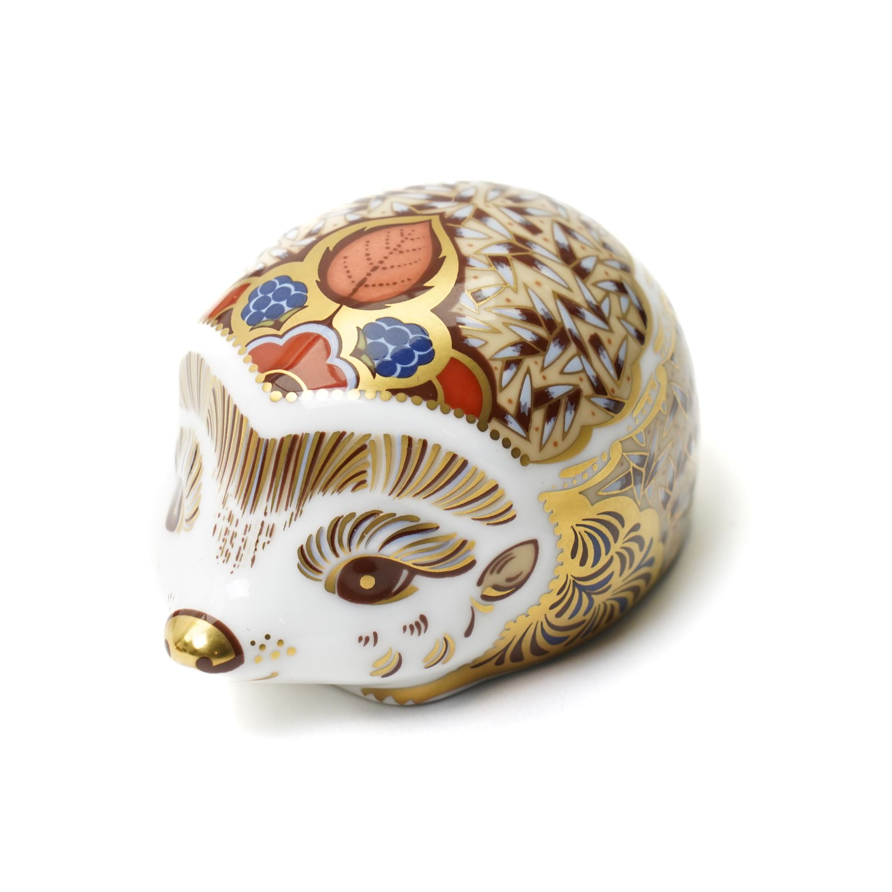 Three Royal Crown Derby paperweights, comprising two of Bramble the Hedgehog, with gold stopper, with boxes, and one of a Woodland Badger, with gold stopper, boxed (3)