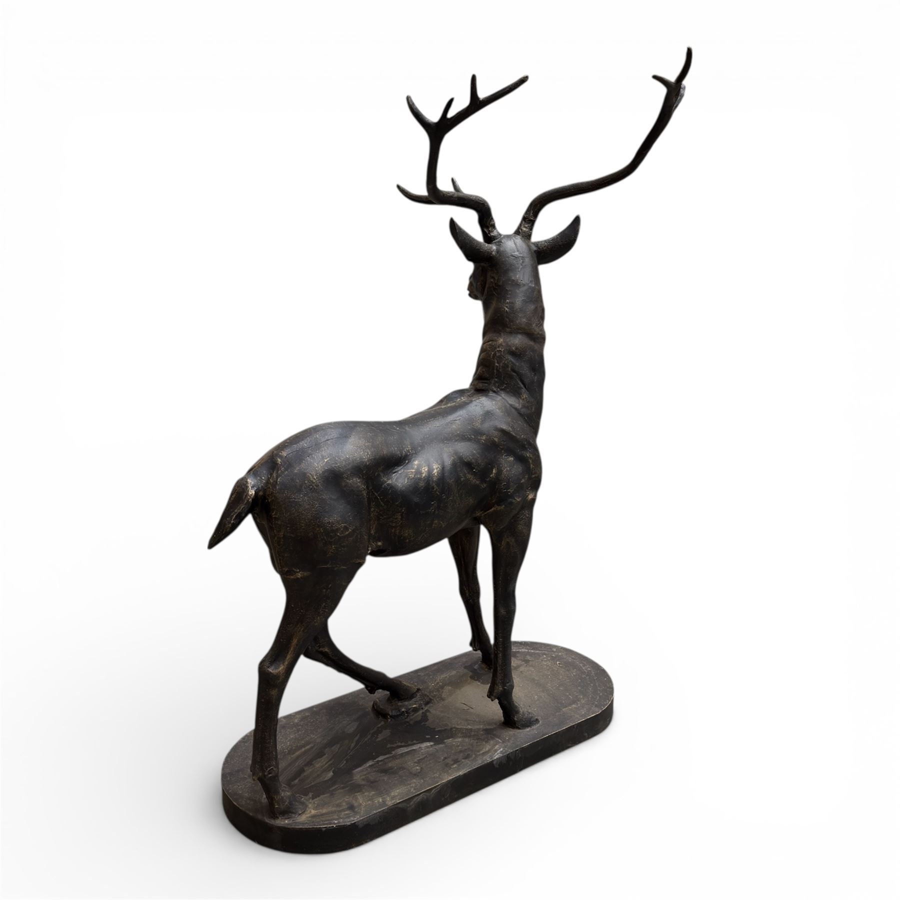 Pair of life-size cast iron garden or home stags, modelled standing upon oval plinths