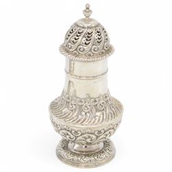 Late Victorian silver sugar caster, of typical waisted form, with embossed scrolling and f...