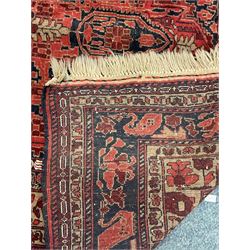 Persian style red ground rug, central medallion (232cm x 148cm) and a runner (322cm x 78cm)