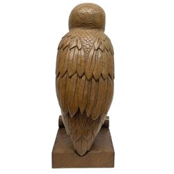 Acornman - carved oak owl perched on branch, on tooled block plinth carved with acorn signature, by the workshop of Alan Grainger, Brandsby (carved by Norman Darnley)