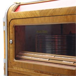Rudolf Wurlitzer Company - Model 616 'Simplex' 1937 jukebox, figured walnut veneered cabinet with illuminated red and amber side panels enclosed by chromed uprights, glazed upper record compartment, cast Art Deco speaker grille, coin-operated push-button selection panel with circular title index, raised on a moulded base