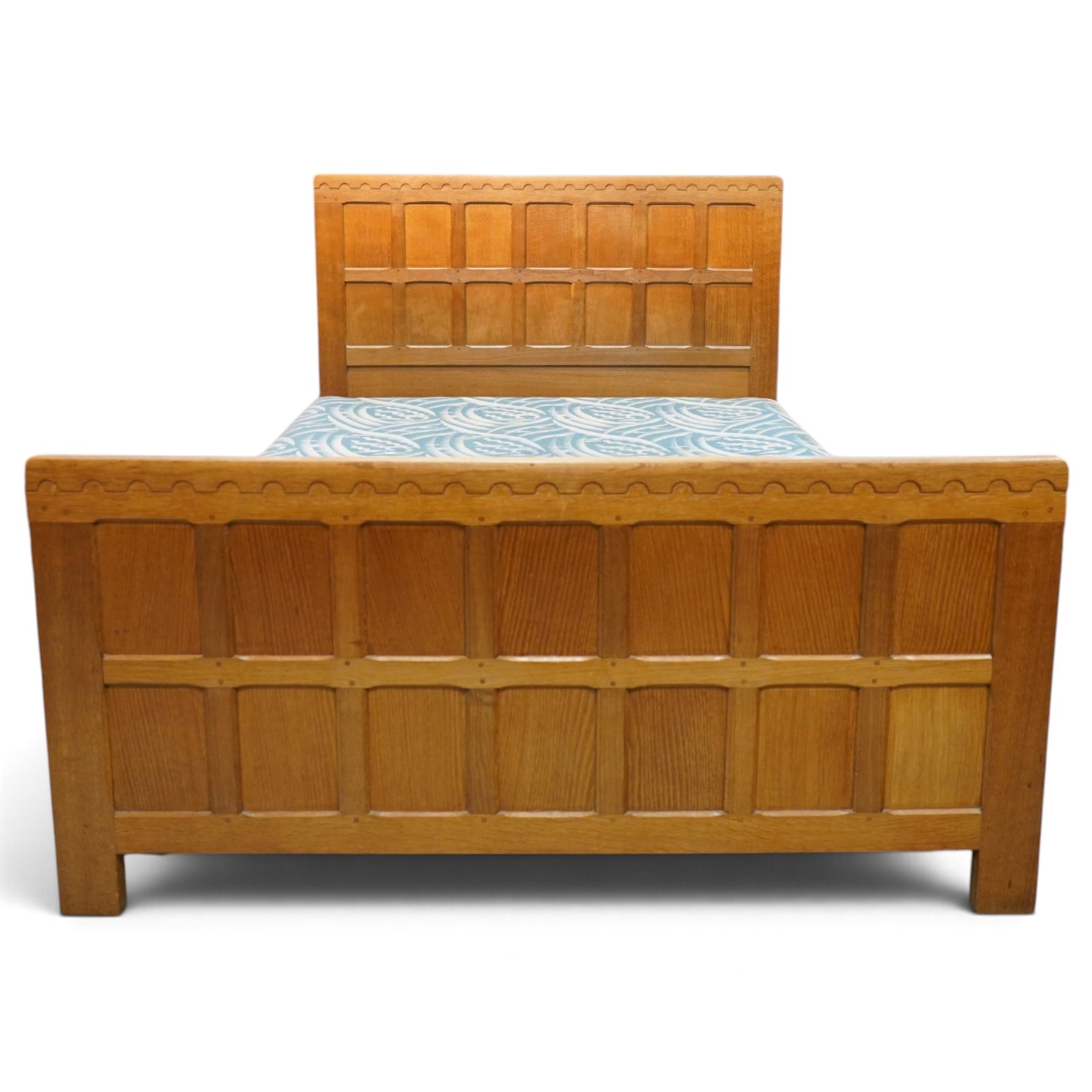 Mouseman - 4'6 panelled oak double bedstead, the head and footboard panelled with arcade carved cresting rails, with bed base and Vono metal rails, with carved mouse signature, by the workshop of Robert Thompson of Kilburn