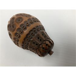 19th century coquilla nut nutmeg grater, modelled as an acorn, with screw threaded cover lifting to reveal a bone collar and steel grater, H7.5cm, together with a 19th century coquilla nut pomander or flea catcher, modelled as a pear and formed of two sections with screw threaded join, H6cm