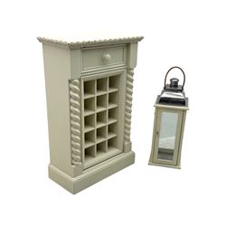 Contemporary painted wooden wine cabinet, rectangular form with carved leaf moulded cornice over single drawer and fifteen bottle compartments, flanked by spiral twist pilasters; together with a cream painted and chrome lantern, with glazed sides and leather handle (2)
