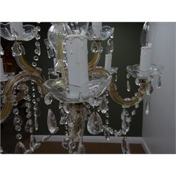  Clear glass nine branch chandelier with cut glass drops, gilt frame and scrolled arms, D62cm  