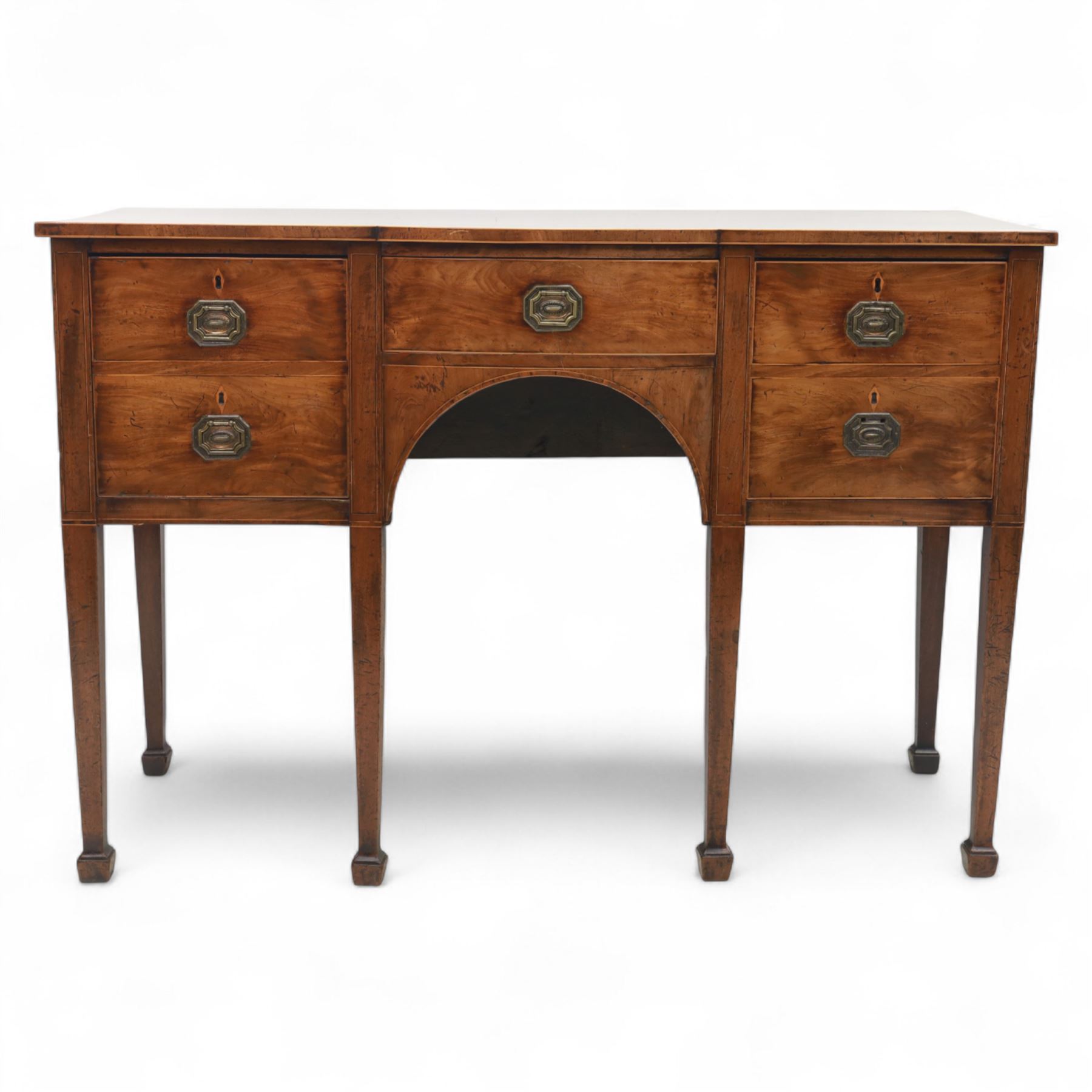 George III Sheraton-style mahogany sideboard, serpentine front fitted with central drawer and flanked by two deep drawers, raised on square tapered legs with spade feet 
