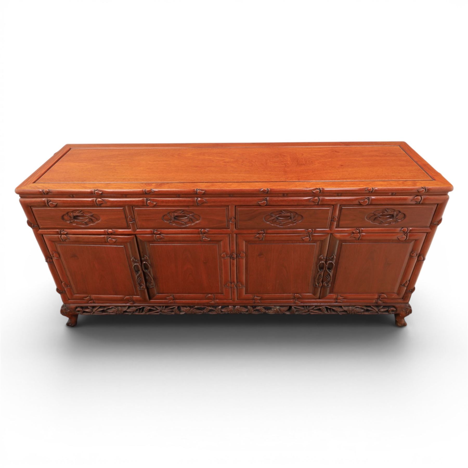 20th century Chinese ornately hardwood sideboard, rectangular top over four drawers above four cupboards, pierced carved apron, raised on cabriole legs 