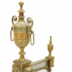 19th century brass and iron fire dogs with fire irons, the fire dogs each with urn finials and arched legs, accompanied by three brass fire tools including shovel, poker and tongs with matching turned handles
