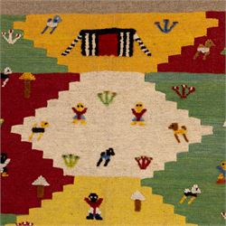 South West Persian Qashqai pictorial flatweave kilim, polychrome field divided into stepped geometric panels decorated with stylized animals, bird, fish and tree motifs with a central ivory lozenge medallion beneath a simple landscape panel with tent motif, figures and and narrow multi-coloured border applied in raised wool pile against a flat-woven ground, fringe ends  