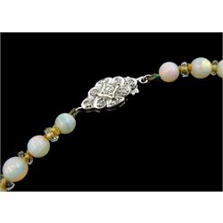 Early 20th century single strand graduating opal bead and faceted crystal bead necklace, on a white gold old cut diamond set clasp, stamped 9ct