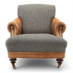 Tetrad - 'Taransay' Harris Tweed and tan leather club armchair, Howard shape with reclined back over deep seat and rolled arms with studwork, raised on turned front supports with castors, the sides and arms upholstered in tan leather with seat and back in herringbone-stitched Harris Tweed