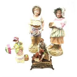  Pair of Continental Bisque figures of a young fisherman and fisherwoman H37cm, Royal Doulton British Sporting Heritage figure 'Henley' and a Capodimonte figure of a boy and his dog on gilt metal plinth (4)   