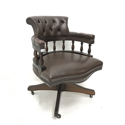 20th century swivel captains chair, upholstered in deep buttoned and studded chocolate leather, four supports, W63cm