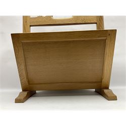 Mouseman - oak magazine rack, the top rail pierced with handle and carved with mouse signature, octagonal supports with two panelled and splayed sides, on sledge feet, by the workshop of Robert Thompson, Kilburn 