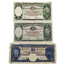 Three Commonwealth of Australia banknotes comprising King George V one pound 'M22 384723' and King George VI five pounds 'R56 516273' and one pound 'H70 801497' 