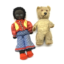 Mid-20th century teddy bear, the plush covered body with applied eyes and nose and stitched mouth, fitted with manual wind musical movement which also turns the head H32cm; and golly with painted features, ear-rings and Romany style costume (2)