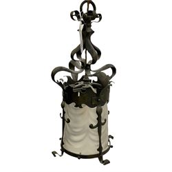 Early 20th century Arts & Crafts patinated brass hall lantern, the shaped mount housing an opaque waved glass shade, H46cm