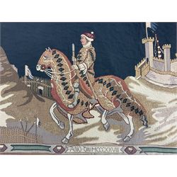 Three tapestries comprising 20th century wool tapestry panel of a medieval nobleman upon a horse with a castle in the distance, together with a smaller tapestry depicting The English Coat of Arms, both hung on rails, and further depicting village scene, largest approx 132cm x 95cm
