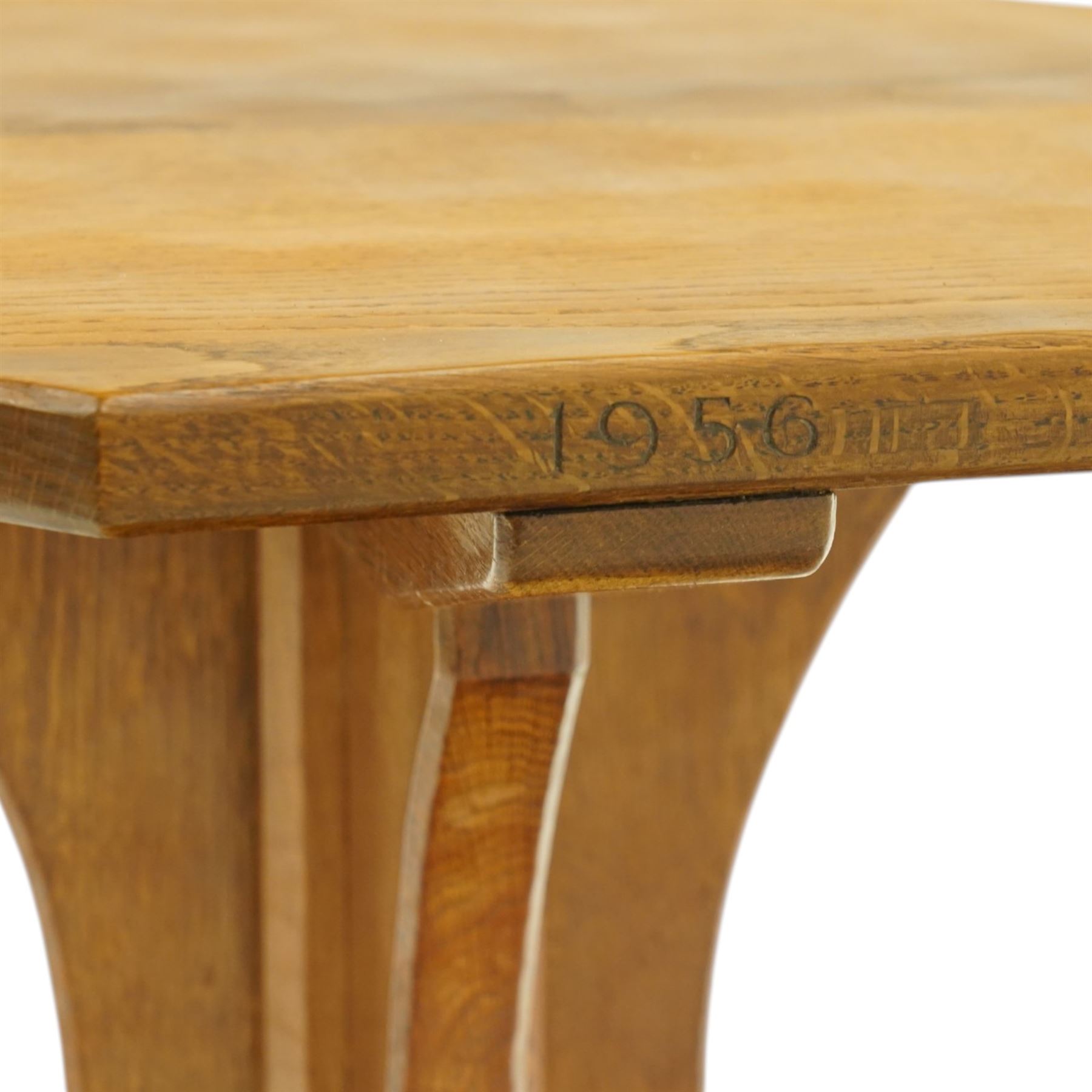 Mouseman - 1950s oak coffee table, octagonal adzed top on cruciform base and sledge feet, carved with mouse signature, dated 1956 and engraved 'Sylvia' to the top edge, by Ken Almack of the workshop of Robert Thompson, Kilburn

Notes:
Made by Ken Almack at the Robert Thompson workshop, Kilburn, where he trained and worked as a Mouseman craftsman; brother of Colin ‘Beaverman’ Almack, who later established his own workshop. The table was made for Sylvia to mark their engagement in 1956, prior to their marriage in 1957.

Provenance: The estate of Ken Almack; Tennants Auctioneers, 20th Century Design, 5 October 2024.