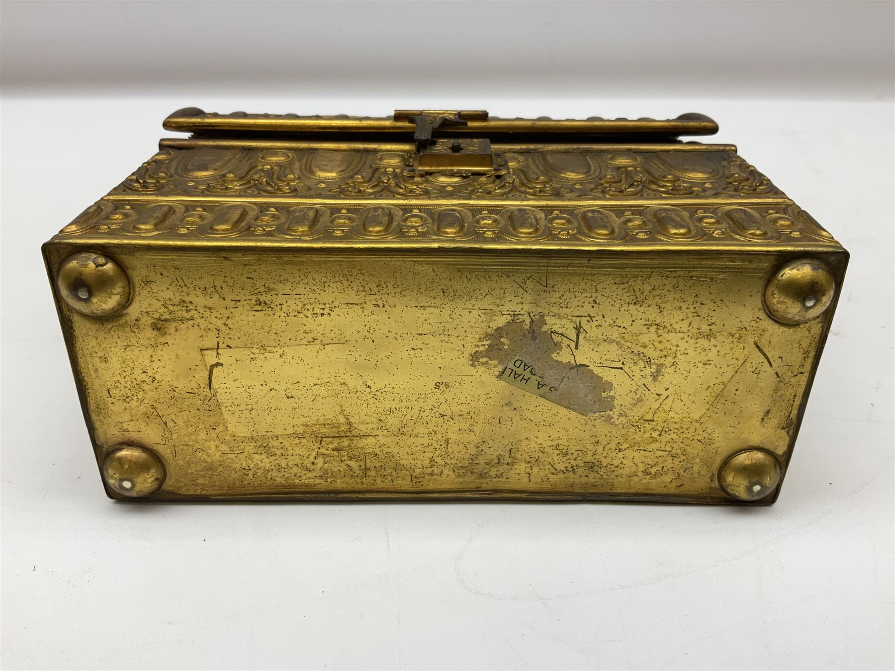 19th century brass repoussé perfume box, the ornately decorated casket with hinged domed cover lifting to reveal gold velvet lined interior containing three glass scent bottles, H14cm W15cm D7cm