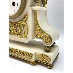 Early 20th century French white marble and ormolu-mounted mantle clock surmounted with a with an ormolu bowl of fruit and grapes, round topped case with corresponding marble side pieces, four gilded finials and applied rocaille decorated panels, on a breakfront plinth with gilded guilloche decoration, plinth raised on ormolu ball and cusp feet, with an eight-day rack striking movement striking the hours and half hours on a bell, rear movement plate stamped “ Marti Medaille d’or Paris 1900”, white convex enamel dial with upright Arabic numerals and minute track with Arabic quarter hours, pierced gilt hands within a convex glass and cast bezel, with pendulum and key. 
*Samuel Marti was a renowned French clockmaker during the 19th century,  establishing his business in 1841 in Montbéliard  a department in northeast France, Marti exhibited his clocks regularly at expositions in Paris, where he won a Bronze Medal in 1860, a Silver Medal in 1889, and several Gold Medals  in1841, 1851, 1852, 1900.


