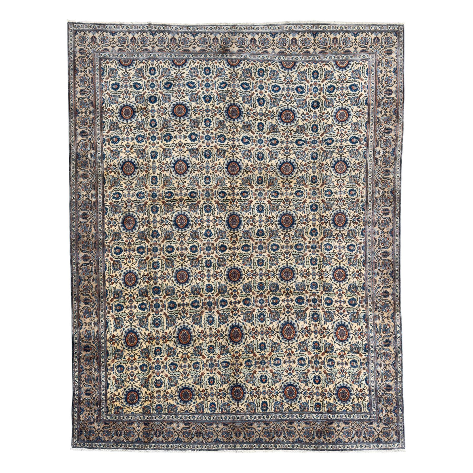 Northwestern Persian Tabriz hand-knotted carpet, the ivory ground with an all-over repeating Herati pattern of stylised palmettes, rosettes and serrated leaves in shades of indigo, terracotta and sky blue, framed by a dark blue border of arabesque vines and scrolling foliage between floral guard stripes, from the region of Tabriz