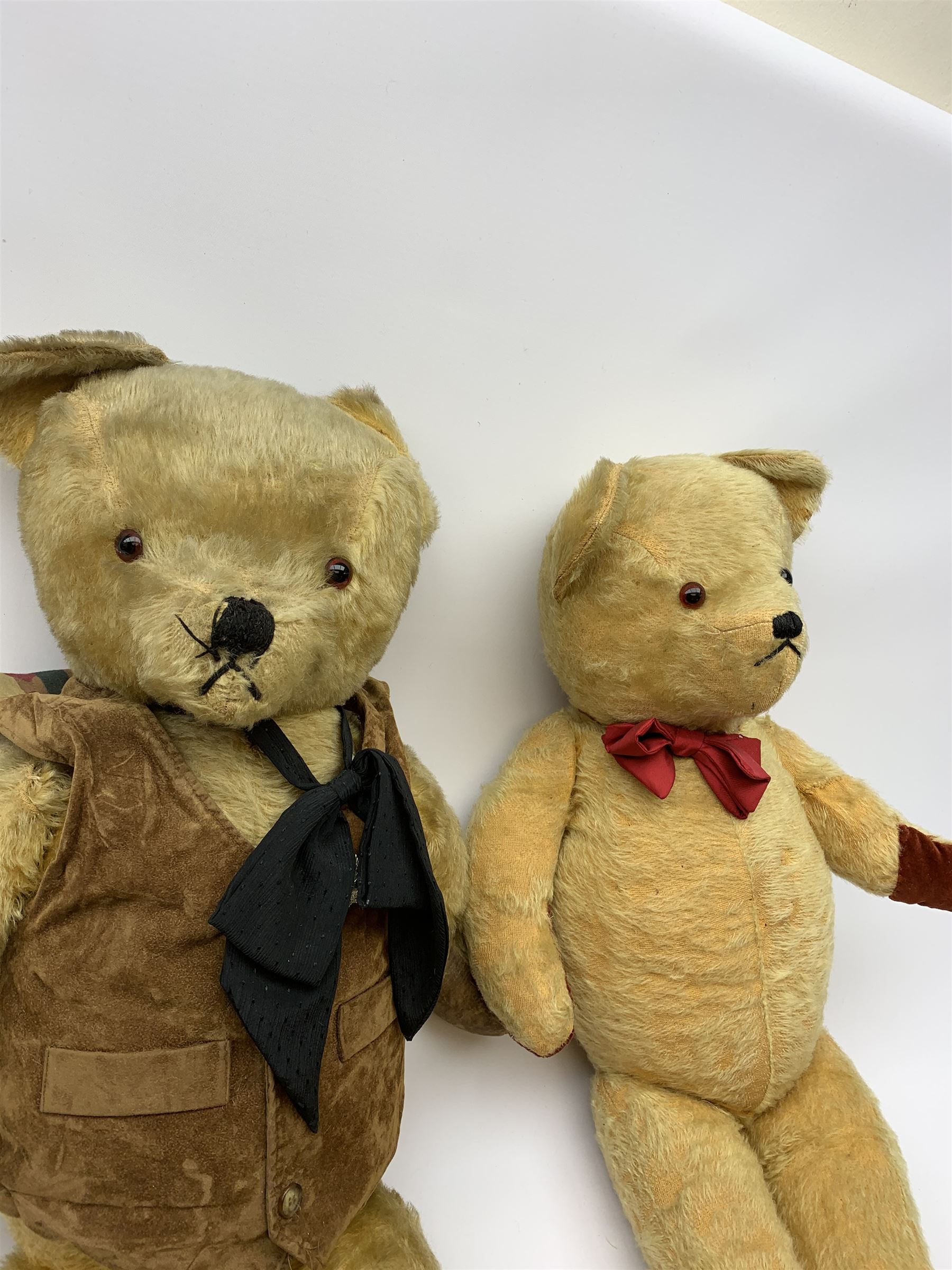 1950s English large wood wool filled teddy bear with swivel jointed head, glass type eyes and vertically stitched nose and mouth and jointed limbs with rexine paw pads H33