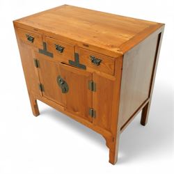 Mid-20th-century Chinese elm side cabinet, rectangular top above three drawers and a pair of panelled cupboard doors, mounted with traditional brass butterfly form handles and pierced circular lock plate 