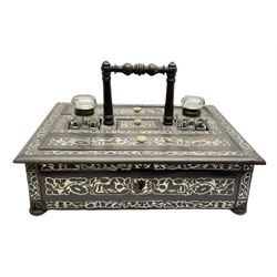 Victorian rosewood and mother of pearl inlaid desk stand, of rectangular form with central carry handle, twin glass inkwells flanking a central stamp compartment, and two pen boxes, upon four compressed bun feet, not including handle H9cm L31cm D25cm